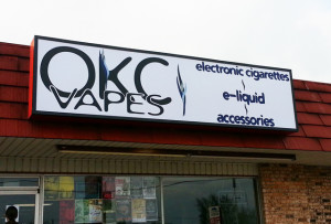 Cabinet wall sign for OKC Vapes.