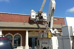 Photo of wall sign being installed.