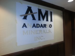 Interior wall sign being installed using a template.