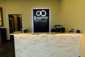 Front picture of halo sign behind reception desk.