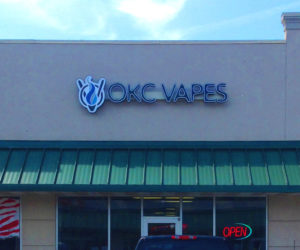 Picture of exterior store sign for OKC Vapes in Norman, OK.