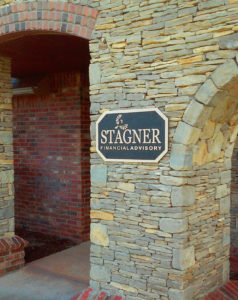 Photo of custom bronze name plaque at company entryway.