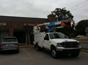 Picture of installation truck removing old sign.