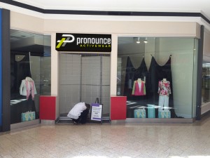 Composite of sign rendering and storefront photo.